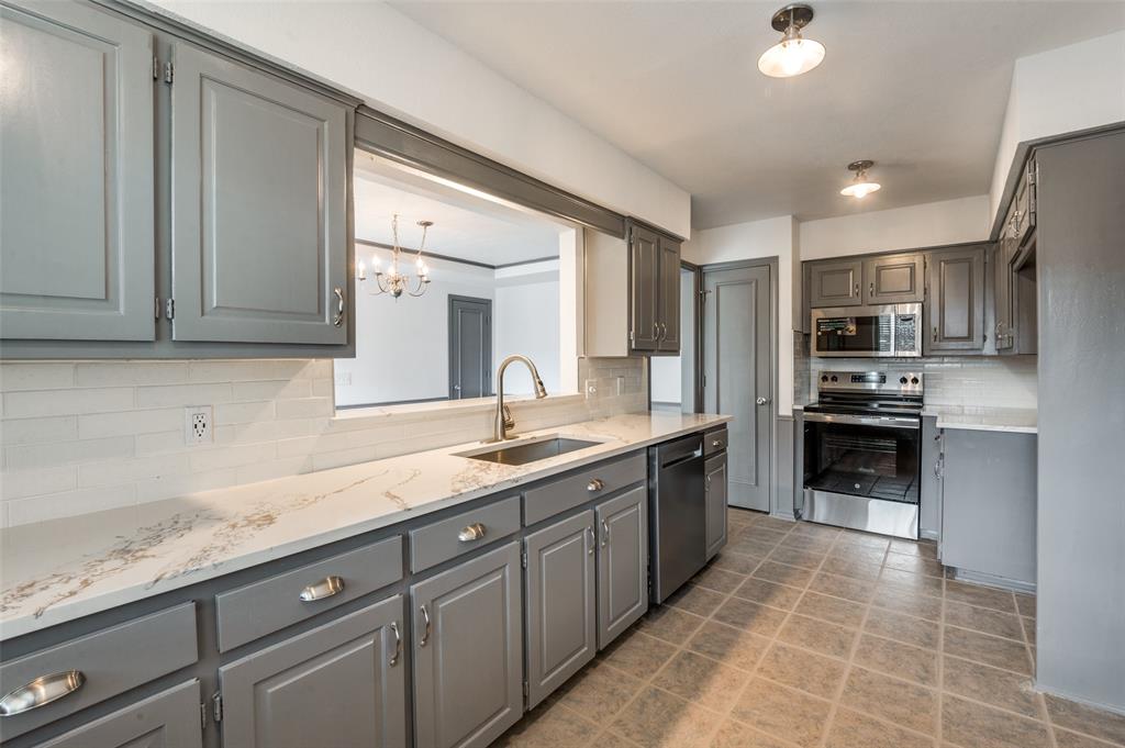 17079 Upper Bay Road Addison, TX 75001 - Photo 4 of 24 a large kitchen with cabinets
