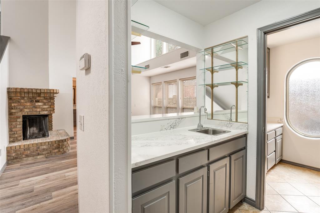17079 Upper Bay Road Addison, TX 75001 - Photo 8 of 24 a en suite bathroom with a granite countertop sink toilet and a mirror