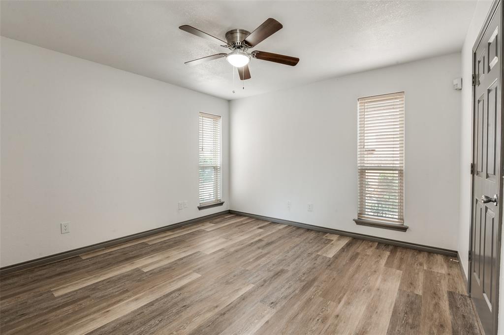 17079 Upper Bay Road Addison, TX 75001 - Photo 10 of 24 an empty room with wooden floor and windows