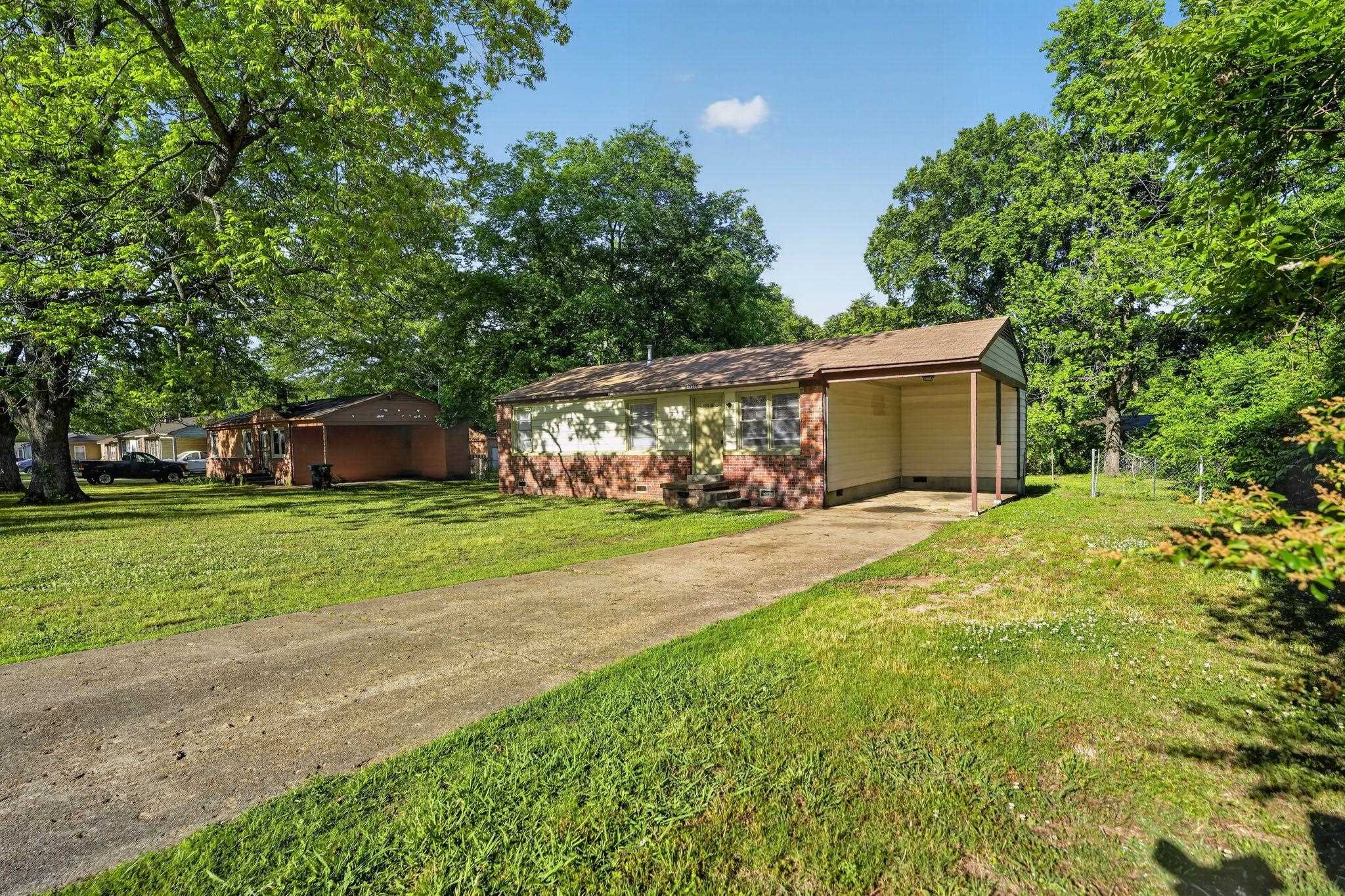 4955 Stacey Road Memphis, TN 38109 - Photo 1 of 35 Exterior featuring brick and siding facade, covered carport, and mature trees