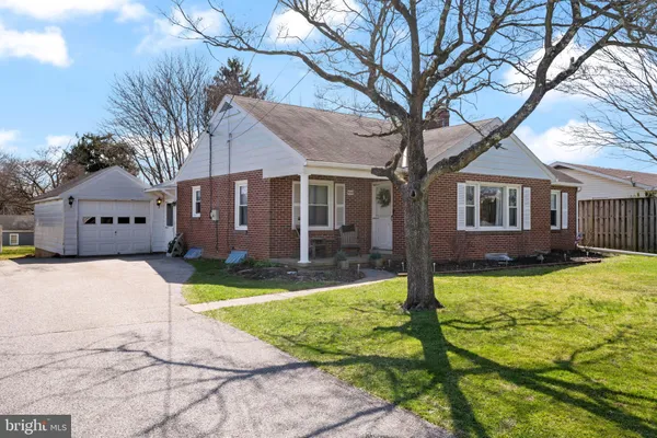 a front view of a house with yard and green space