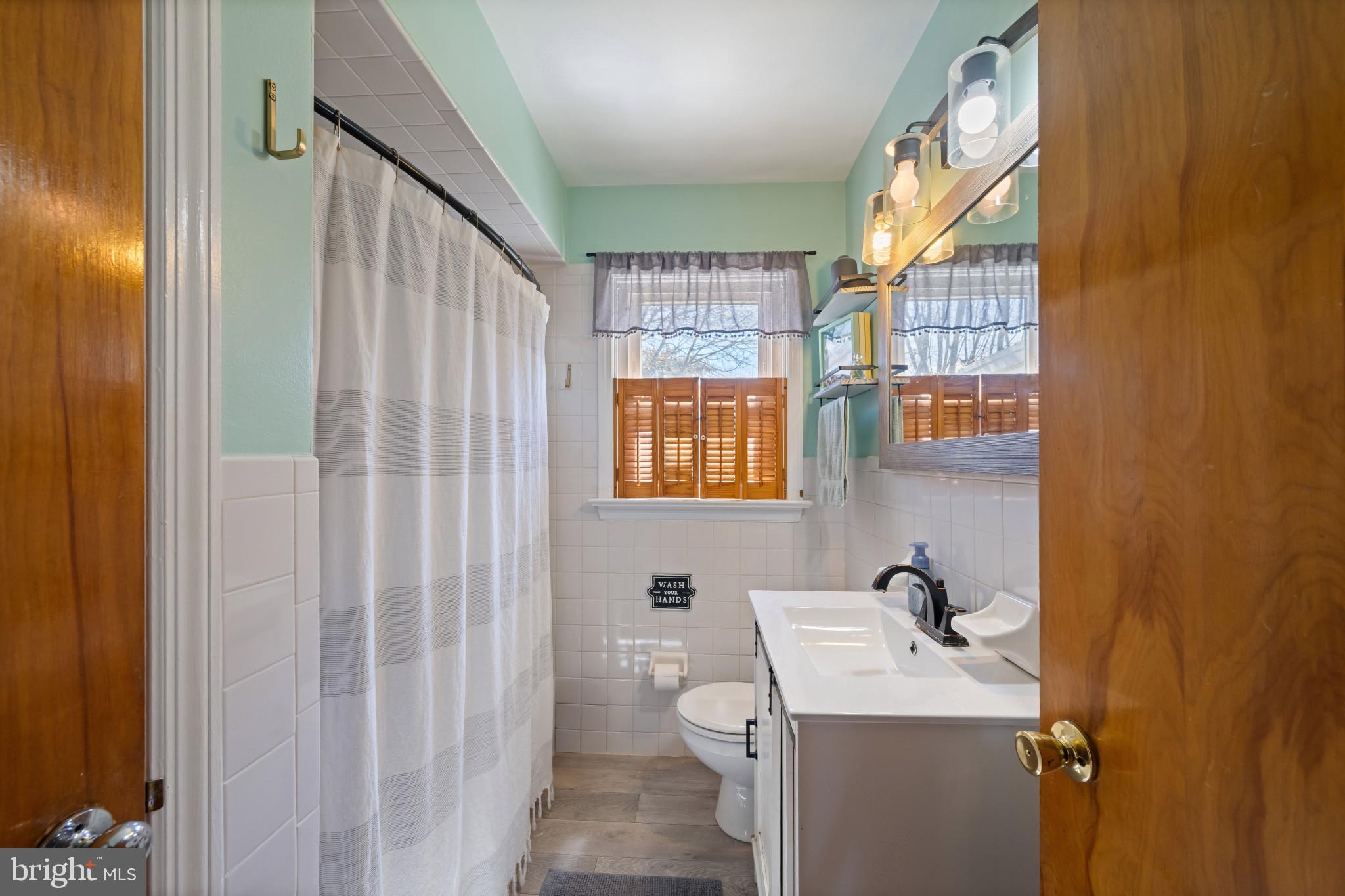 4207 Ralph Avenue Hampstead, MD 21074 - Photo 14 of 33 a bathroom with a sink a toilet and a mirror