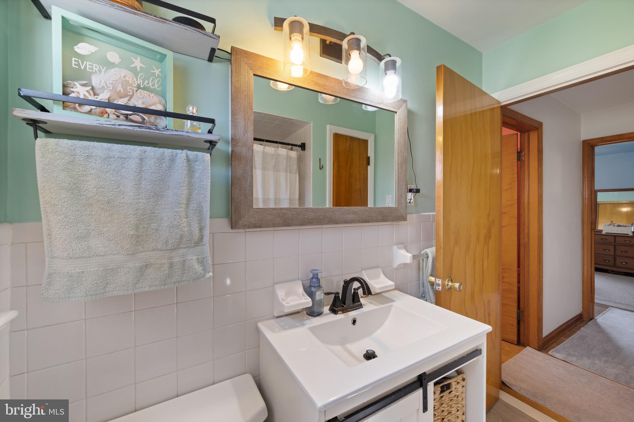 4207 Ralph Avenue Hampstead, MD 21074 - Photo 15 of 33 a bathroom with a sink a mirror and vanity