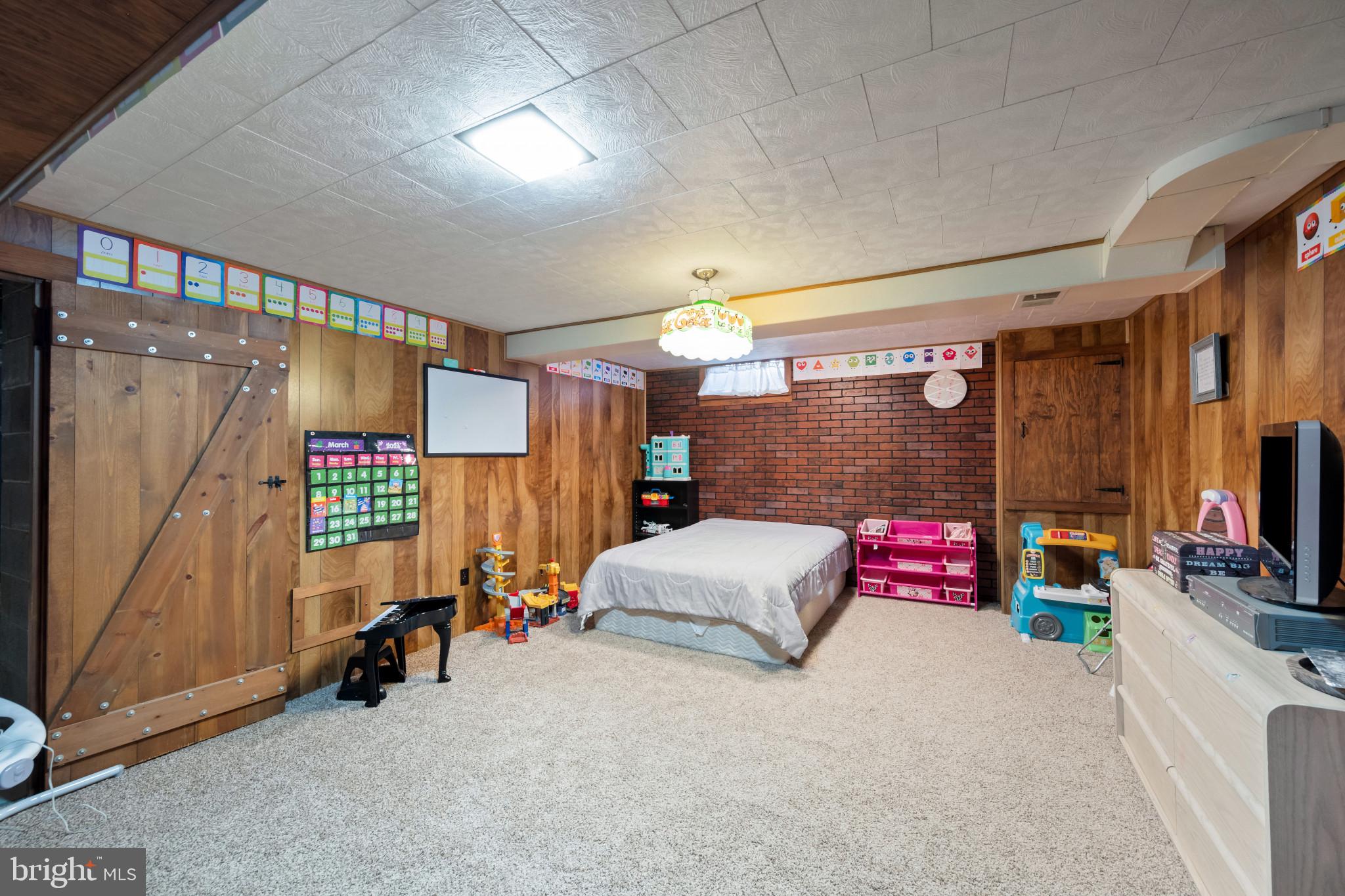 4207 Ralph Avenue Hampstead, MD 21074 - Photo 23 of 33 a bedroom with furniture and a flat screen tv