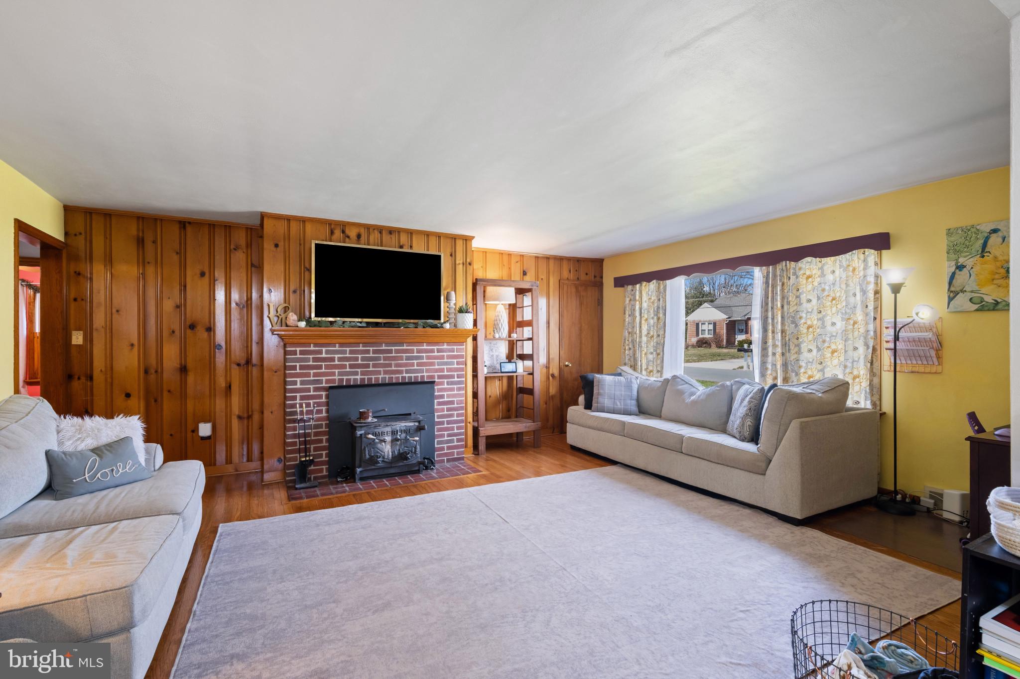 4207 Ralph Avenue Hampstead, MD 21074 - Photo 5 of 33 a living room with furniture a fireplace and a flat screen tv