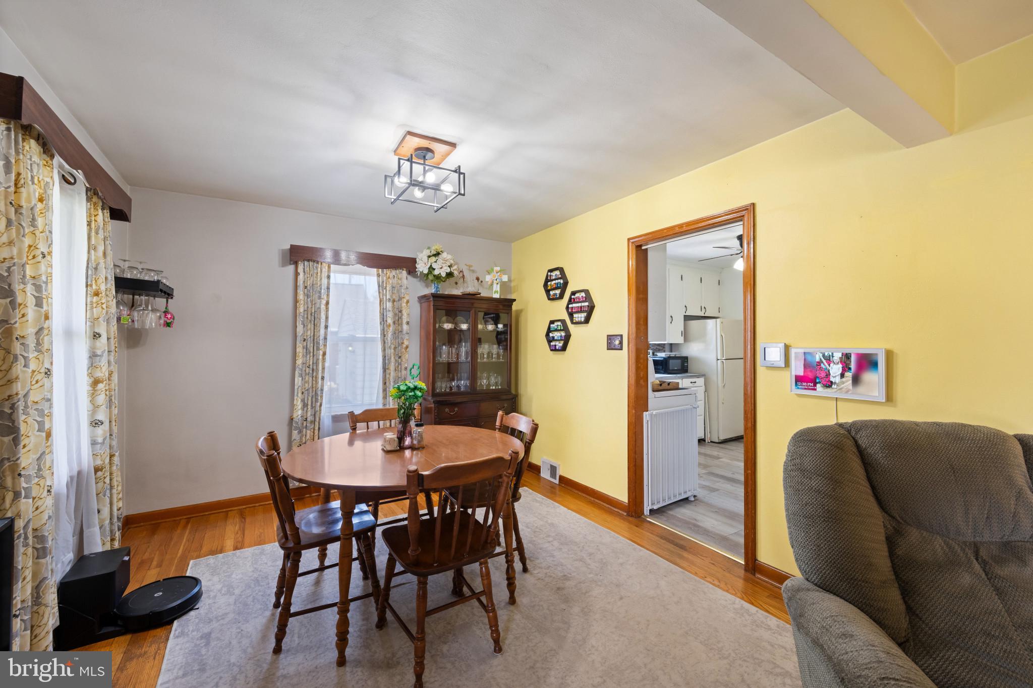 4207 Ralph Avenue Hampstead, MD 21074 - Photo 7 of 33 a view of a dining room with furniture and wooden floor
