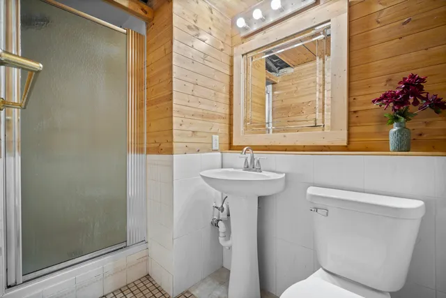 a bathroom with a sink a mirror and a toilet