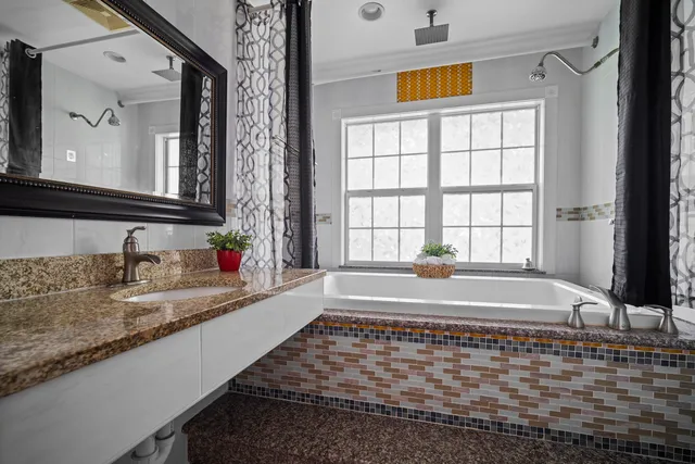 a bathroom with a bathtub and a sink
