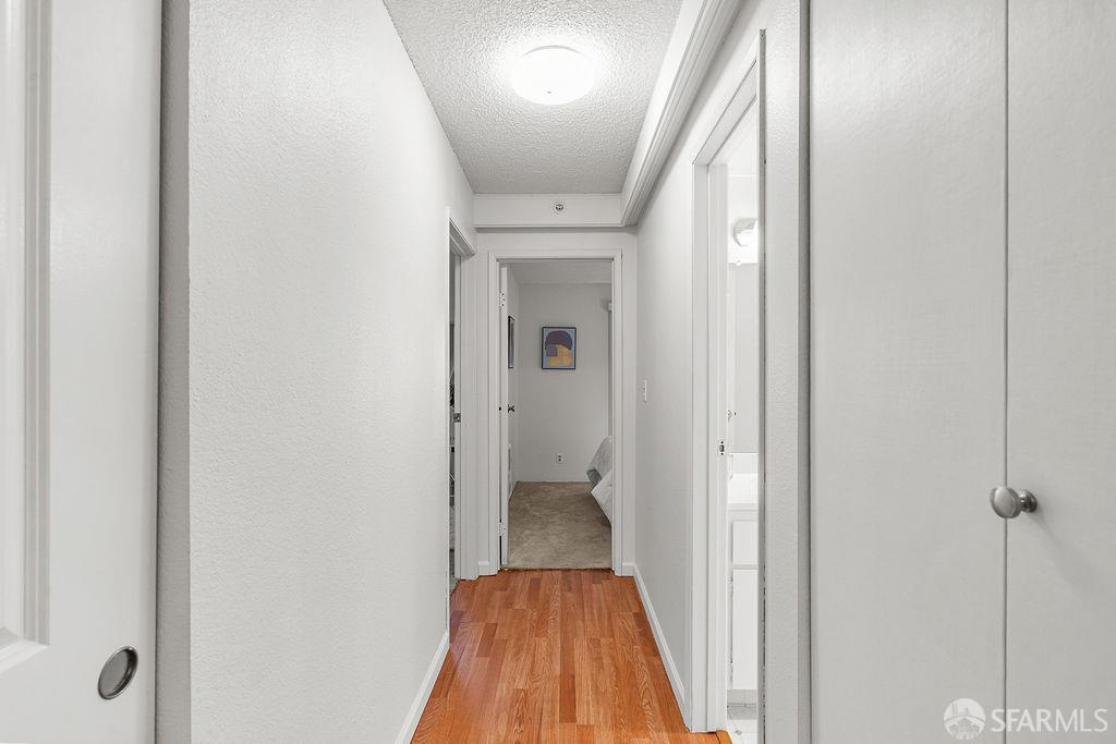 332 Philip Drive, Unit 103 Daly City, CA 94015 - Photo 13 of 37 a view of a hallway with wooden floor and a bathroom