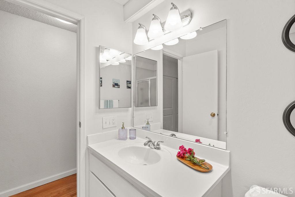 332 Philip Drive, Unit 103 Daly City, CA 94015 - Photo 14 of 37 a bathroom with a sink vanity mirror and vanity