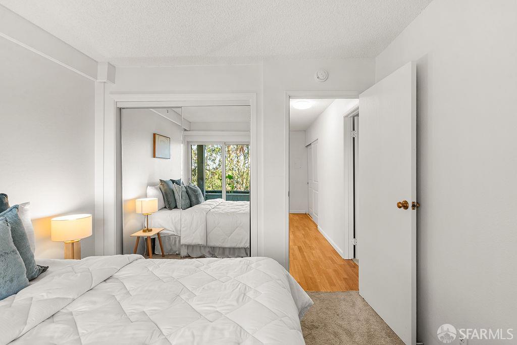 332 Philip Drive, Unit 103 Daly City, CA 94015 - Photo 17 of 37 a bedroom with a bed and a potted plant