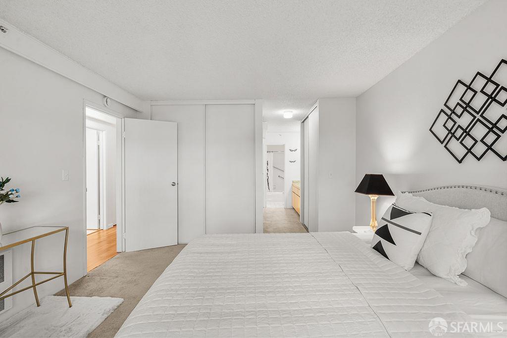 332 Philip Drive, Unit 103 Daly City, CA 94015 - Photo 21 of 37 a bedroom with a bed and a chandelier