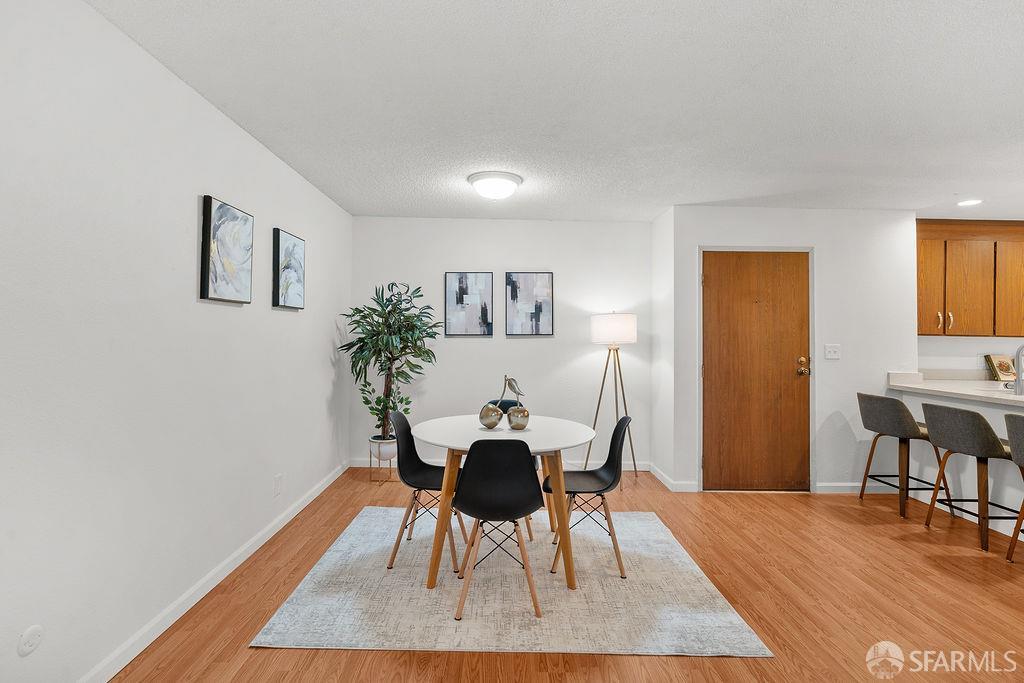332 Philip Drive, Unit 103 Daly City, CA 94015 - Photo 4 of 37 a view of a dining room with furniture and wooden floor