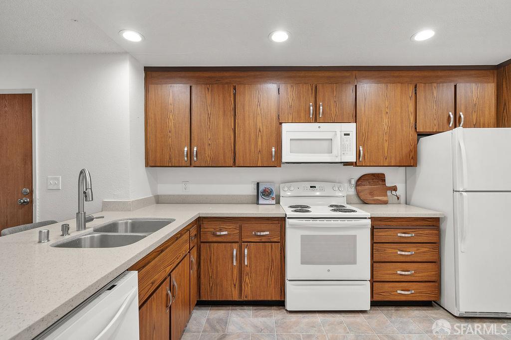 332 Philip Drive, Unit 103 Daly City, CA 94015 - Photo 8 of 37 a kitchen with a sink a refrigerator and cabinets