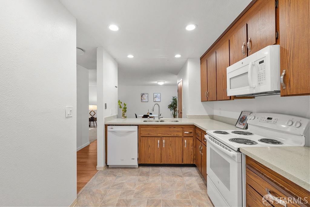 332 Philip Drive, Unit 103 Daly City, CA 94015 - Photo 10 of 37 a kitchen with a sink a stove a refrigerator and cabinets