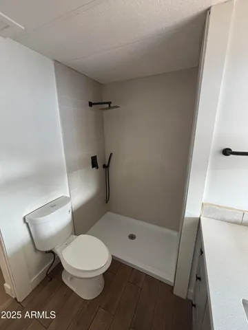 a white toilet sitting next to a bath tub