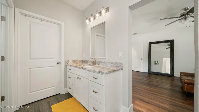 a bathroom with a sink a toilet and a window