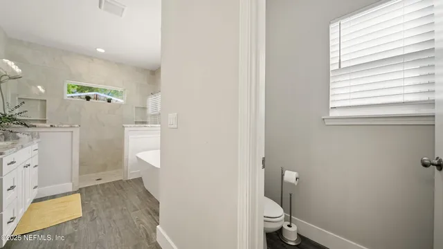 a spacious bathroom with a sink a mirror and a shower