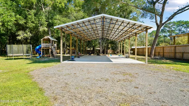 a view of yard with swimming pool and trees