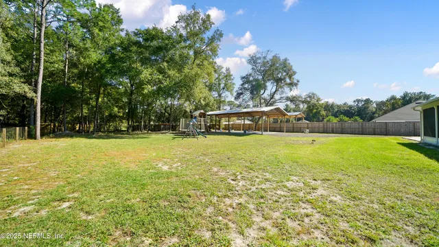 an aerial view of residential houses with outdoor space and swimming pool