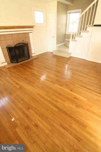 703 Dorchester Road Baltimore, MD 21229 - Photo 2 of 27 a view of empty room with wooden floor and fan