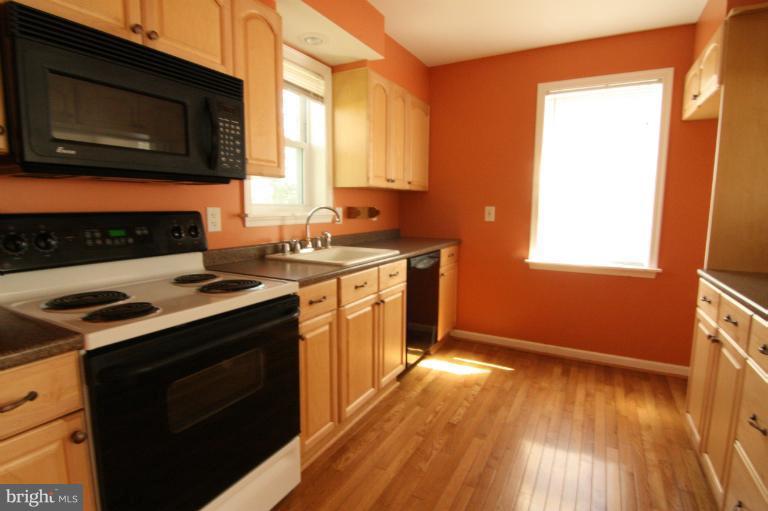 703 Dorchester Road Baltimore, MD 21229 - Photo 12 of 27 a kitchen with a stove and a microwave