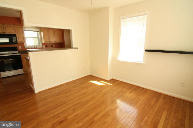 703 Dorchester Road Baltimore, MD 21229 - Photo 14 of 27 a view of a kitchen with wooden floor and a sink