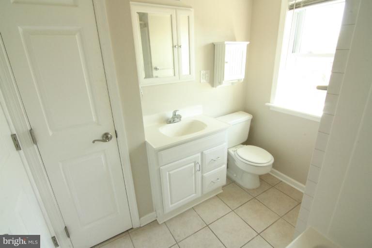 703 Dorchester Road Baltimore, MD 21229 - Photo 19 of 27 a white toilet sitting next to a bathroom sink