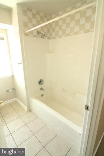 703 Dorchester Road Baltimore, MD 21229 - Photo 3 of 27 a bathroom with a bathtub and a shower