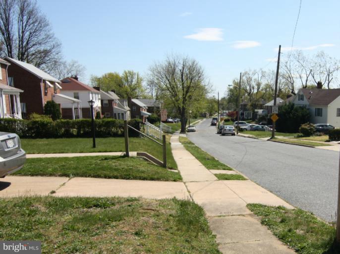 703 Dorchester Road Baltimore, MD 21229 - Photo 22 of 27 a view of a house with a yard and plants