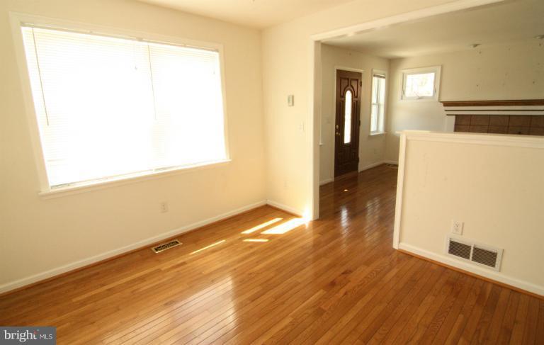 703 Dorchester Road Baltimore, MD 21229 - Photo 26 of 27 a view of a room with wooden floor and a window