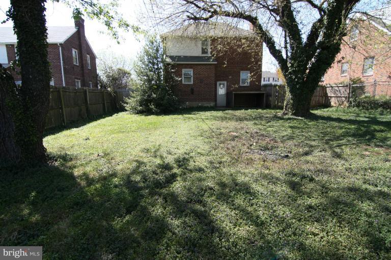 703 Dorchester Road Baltimore, MD 21229 - Photo 7 of 27 a front view of a house with a yard