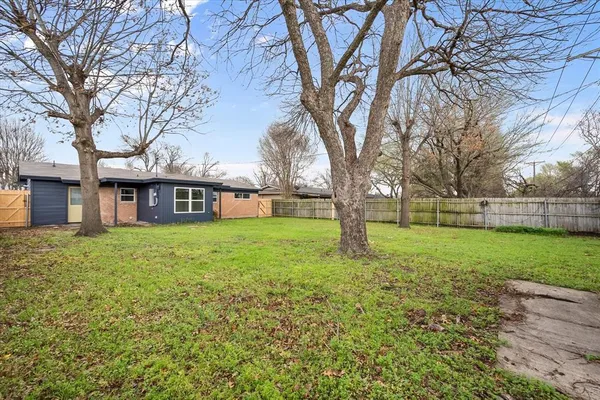 a brick house with trees in front of it
