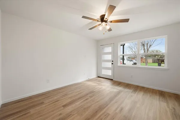 wooden floor in an empty room with a window