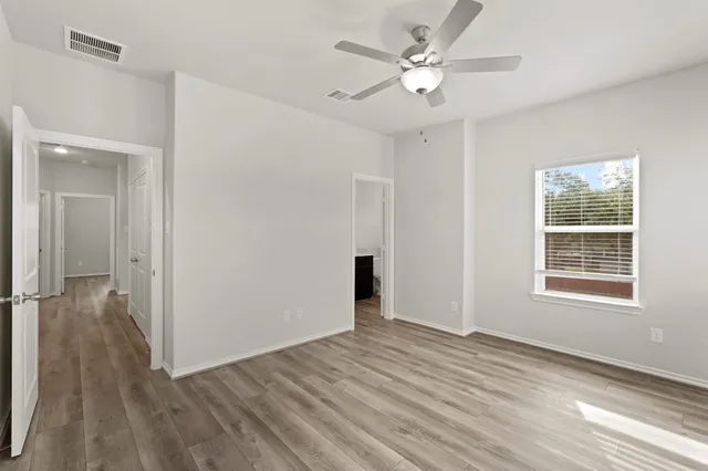 wooden floor in an empty room with a window
