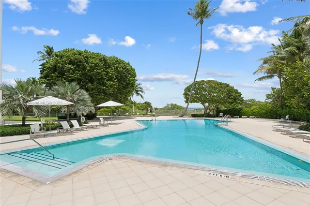 a view of building with yard and swimming pool
