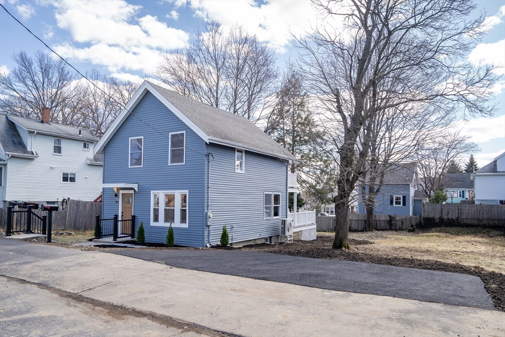56 Riverview Street Dedham, MA 02026 - Photo 29 of 29 a front view of a house with a yard and garage