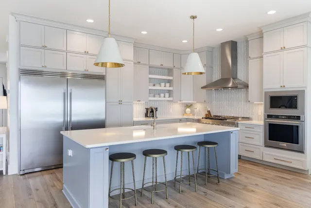 a living room with furniture kitchen and a table