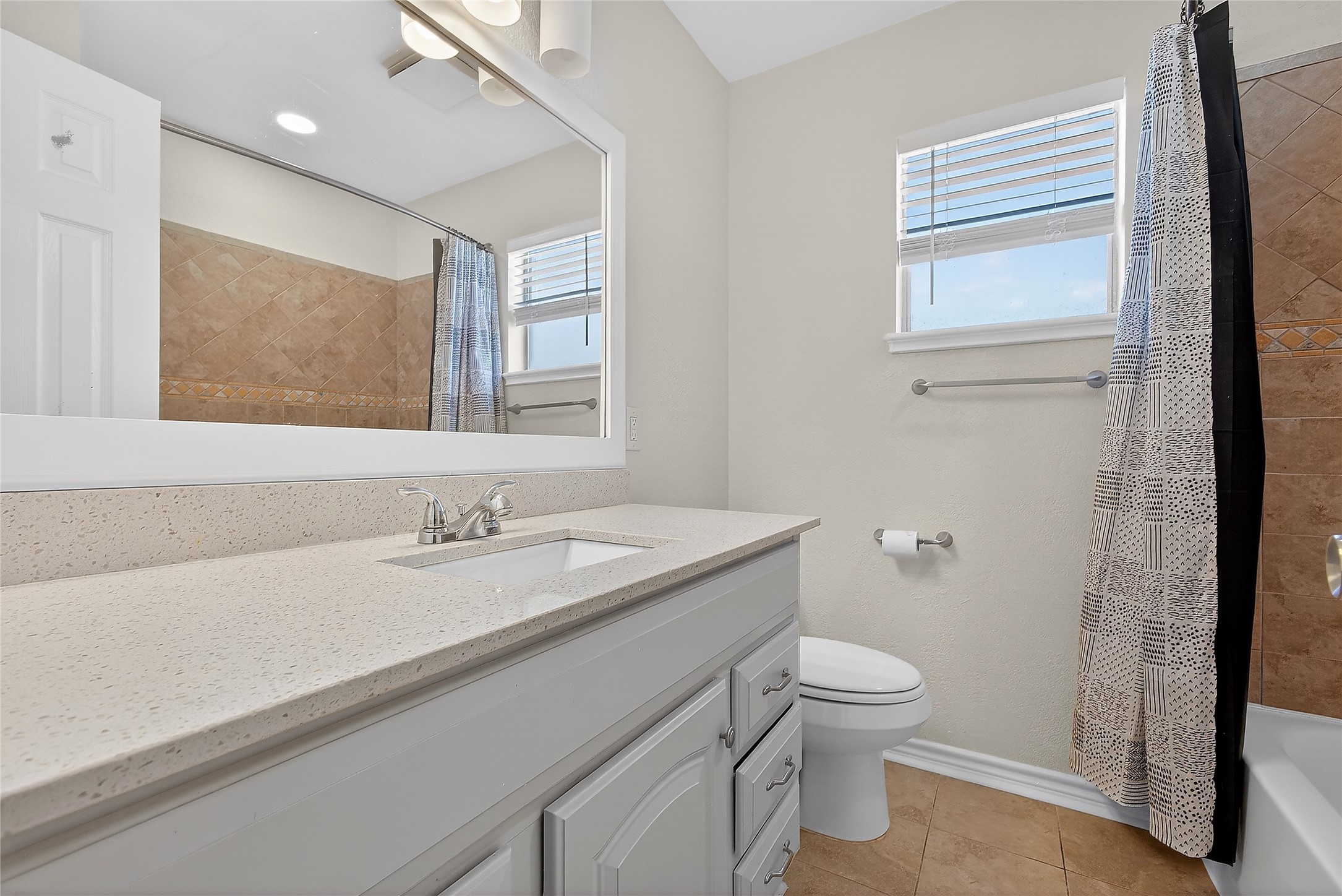 1221 Cedar Post Lane, Unit 1B Houston, TX 77055 - Photo 14 of 23 a bathroom with a granite countertop sink a toilet and a mirror