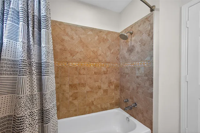 a bathroom with a bathtub and shower