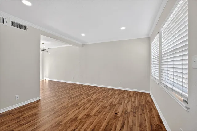 wooden floor in an empty room with a window
