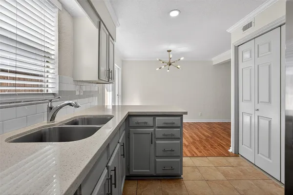 a kitchen with a sink and cabinets