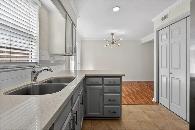 a kitchen with a sink and cabinets