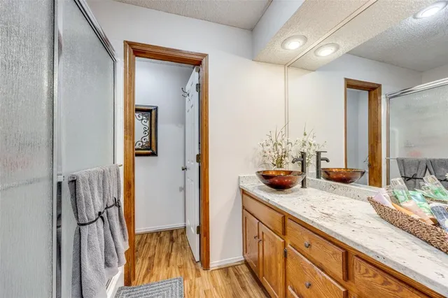 a bathroom with a granite countertop sink a toilet and a mirror