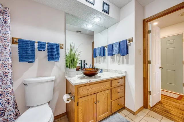 a view of bathroom with a potted plant on the counter shower and a sink