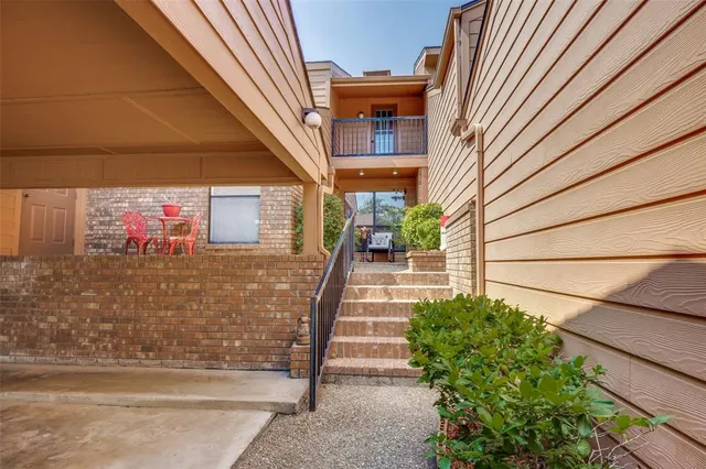 a view of a backyard with plants and a barbeque