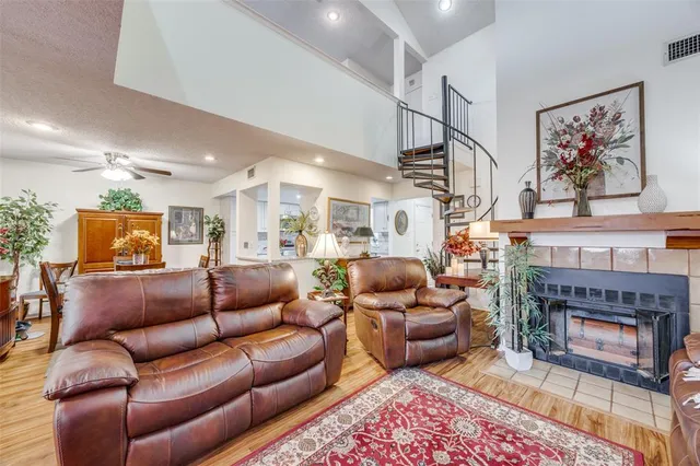 a living room with furniture a fireplace and a table