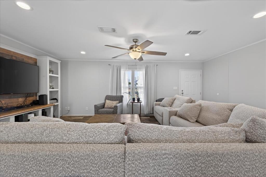 3605 Mockingbird Circle Cleburne, TX 76031 - Photo 12 of 40 Living room with ornamental molding, recessed lighting, ceiling fan, and wood finished floors