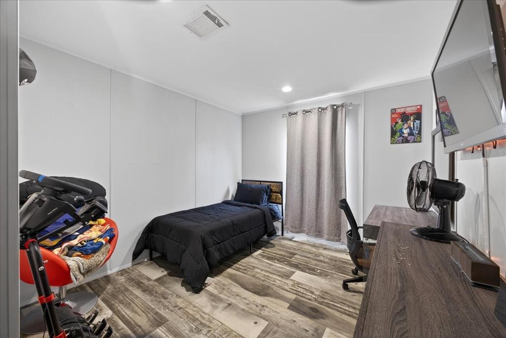 3605 Mockingbird Circle Cleburne, TX 76031 - Photo 31 of 40 Bedroom featuring wood finished floors, an office area, and recessed lighting