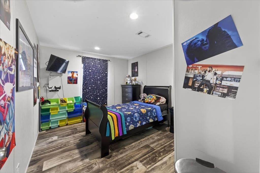 3605 Mockingbird Circle Cleburne, TX 76031 - Photo 34 of 40 Bedroom featuring dark wood-style flooring and recessed lighting